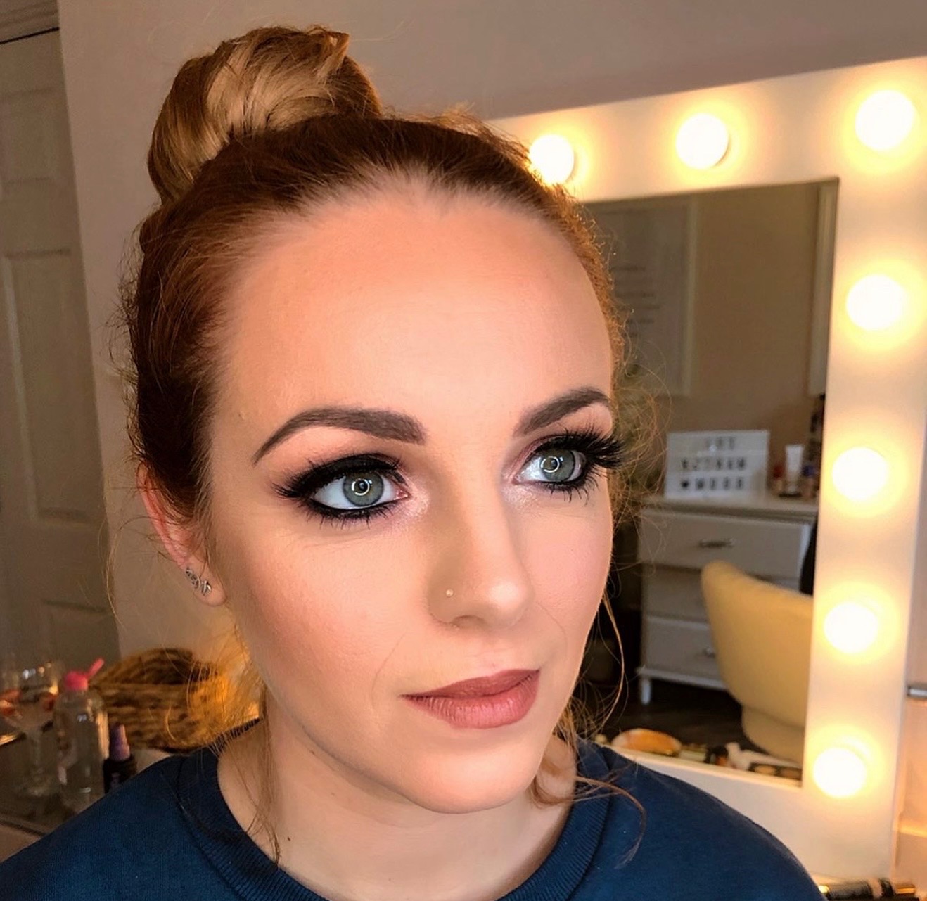 Client portrait with rosy eyeshadow, dark liner and a rose lip